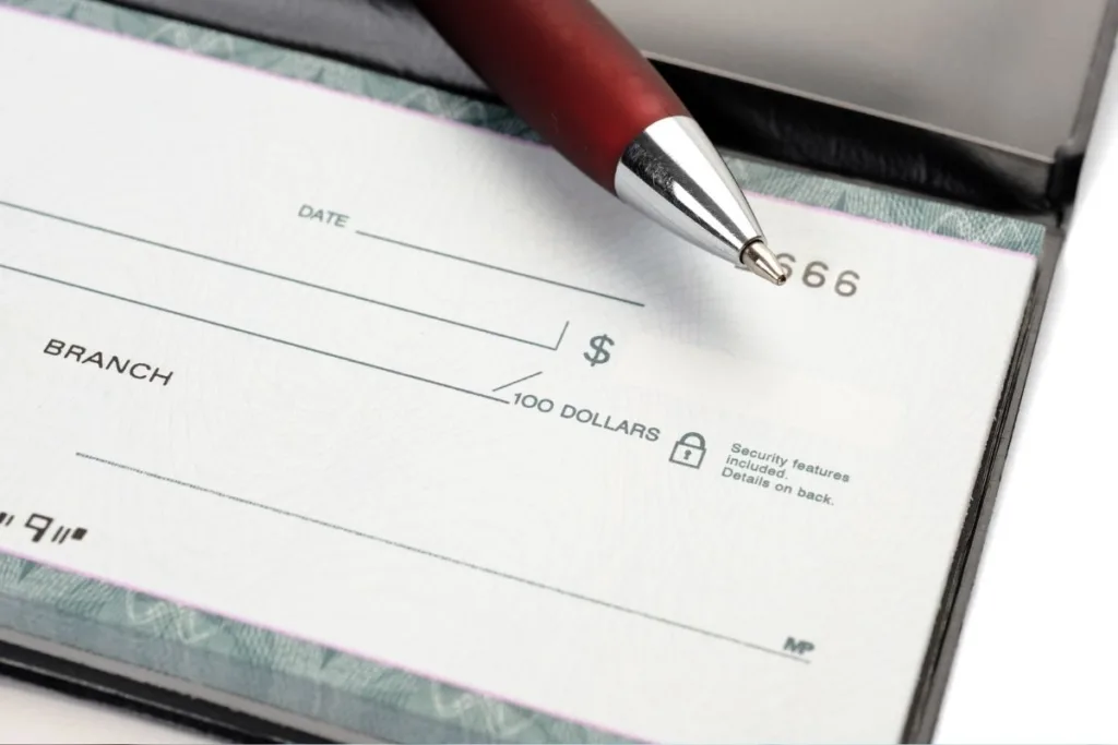 Blank bank check with pen ready for Check Cashing services
