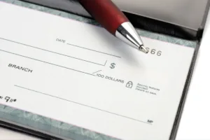 Blank bank check with pen ready for Check Cashing services