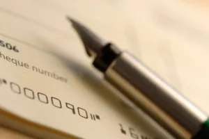 Close-up of fountain pen on document used to Cash a check.