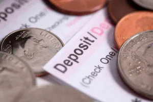 Coins placed on deposit slip used to Cash a check.
