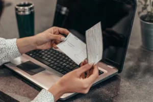 Woman holding check slip ready for Check Cashing transaction.