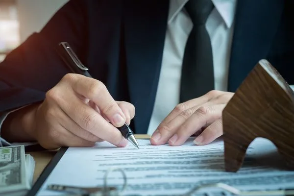 Business Professional Reviewing Contract Before Check Cashing