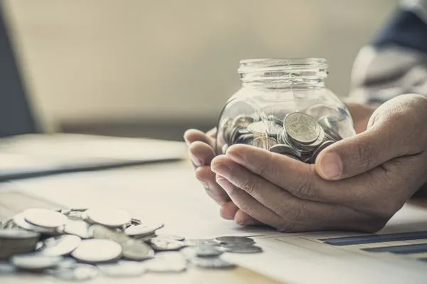 Hands Holding Savings Jar After Smart Check Cashing Decision
