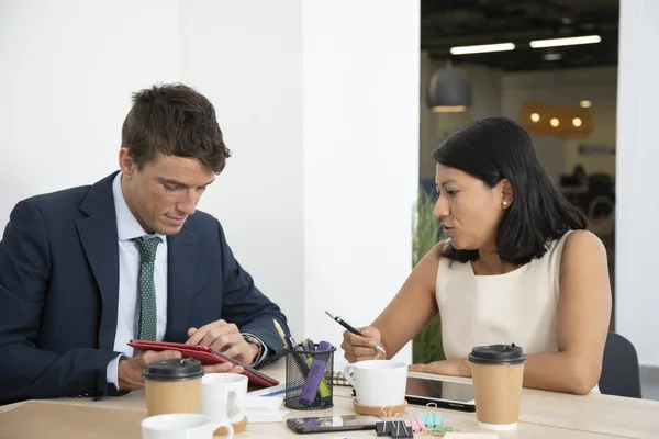  Employees discussing check cashing for business use
