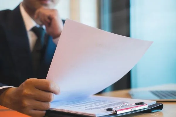 Business Professional Reviewing Contract Before Check Cashing
