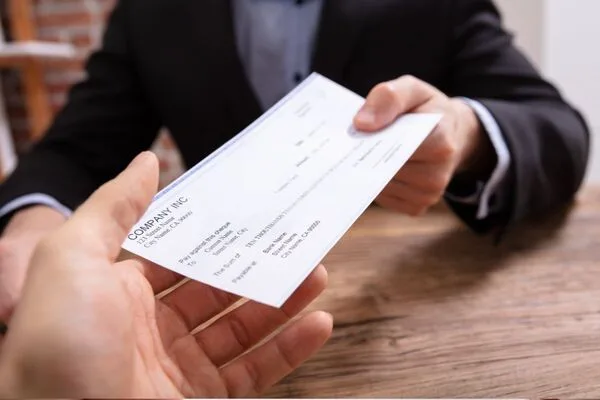 Businessman returning a check due to a failed Check Cashing transaction.