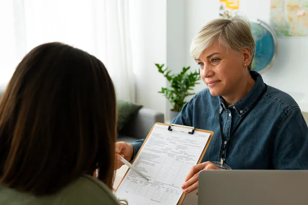 Woman discussing insurance check expiration details with advisor