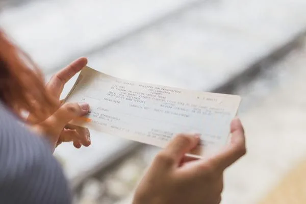 Woman carefully reading check details before cashing
