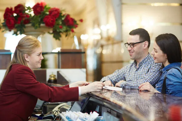Smiling couple cashing a check at counter