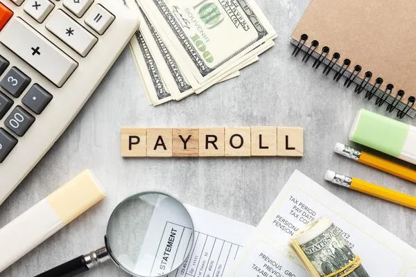 Payroll checks with money calculator and pay statement