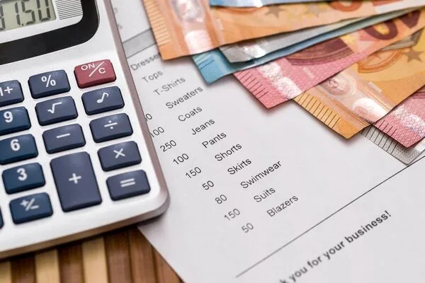  Financial invoice paperwork, euro banknotes, calculator, and Money Order.
