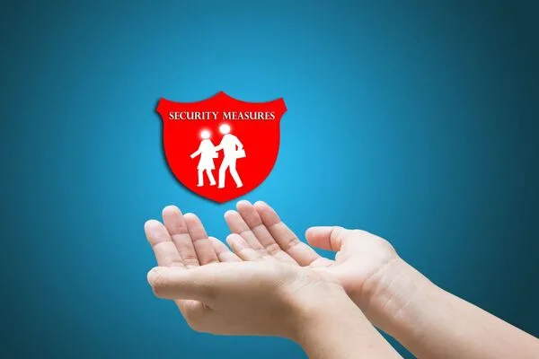 Protective hands beneath shield representing Money Order safety measures.