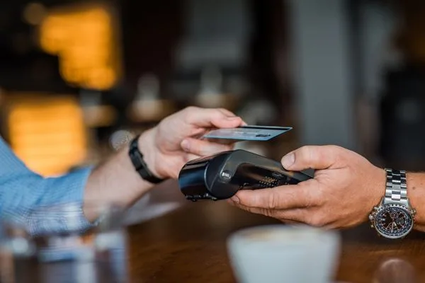Customer making payment after check cashing transaction