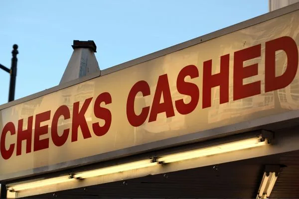 Large illuminated sign shows location where you Cash a check.