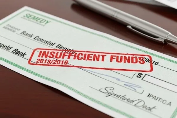 Bounced check stamped “insufficient funds” during check cashing