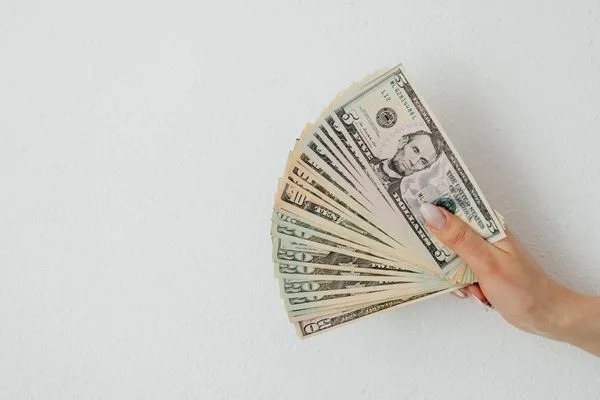 Hand Holding Cash For Secure Money Transfer Transactions