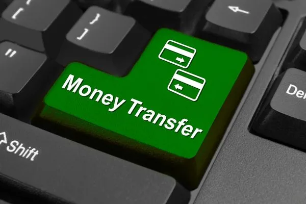 Keyboard button highlighting secure online money transfer process