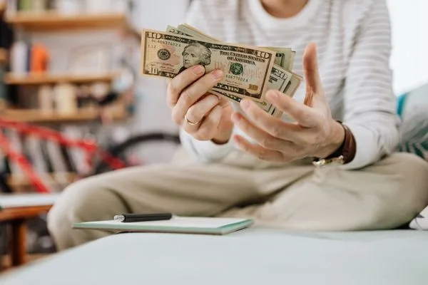 Man Counting Cash At Home For Money Transfer