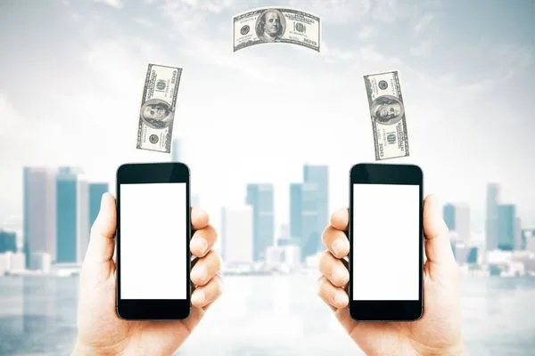 Mobile money transfer concept showing phones exchanging cash.