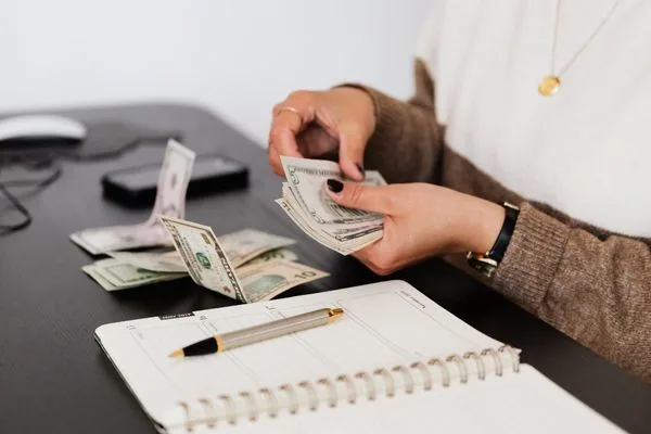 Money Transfer Preparation With Cash And Notebook