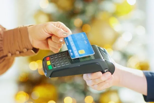 Electronic money transfer using debit card payment terminal