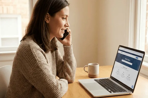 Woman calling support about Money Transfer using laptop