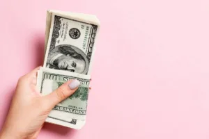 Mano sosteniendo dinero en efectivo como símbolo de un servicio seguro de cambio de divisas