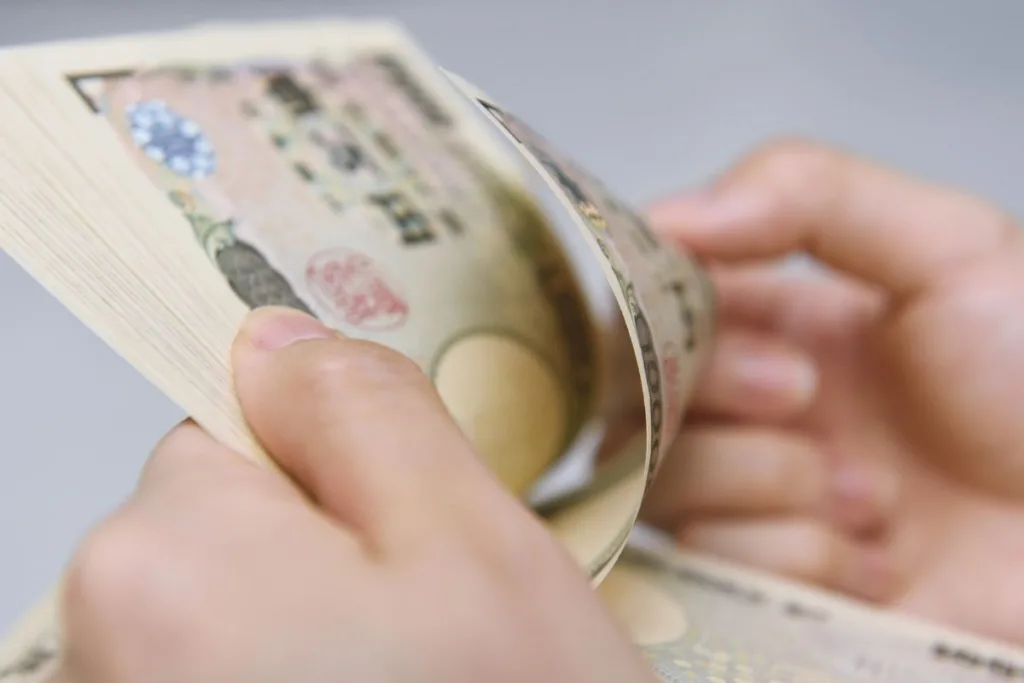 Persona contando dinero durante una transacción de cambio de cheque