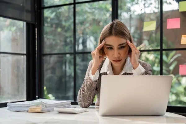 Business professional facing Check Cashing issues on laptop