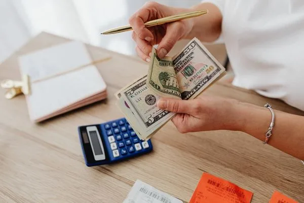 Manejo de efectivo mediante transferencia de dinero con calculadora y recibos