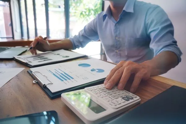 Man reviewing financial documents for Check Cashing preparation