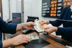 Customer completing Currency Exchange at service counter