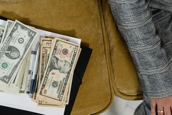 Cash And Documents For Currency Exchange Preparation On Table