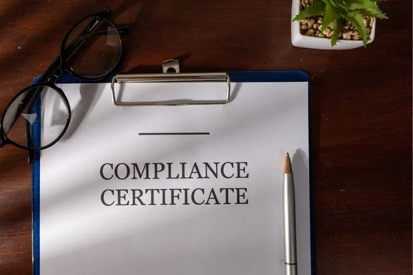 Currency Exchange compliance certificate on clipboard with glasses and pen