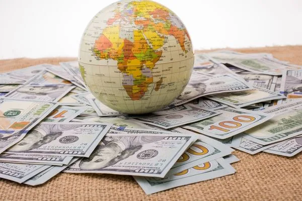 World Globe On Dollar Bills Representing Global Currency Exchange