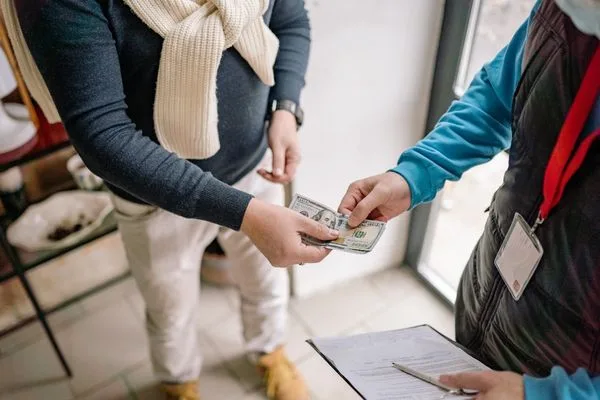 In Person Currency Exchange Cash Transaction With Customer And Staff
