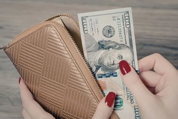 Woman Taking Dollars Currency Exchange From Wallet Concept
