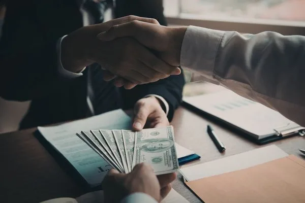 Hands Exchanging Currency Exchange Cash With US Dollar Bills