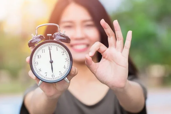 Woman Holding Clock Currency Exchange Timing Concept With Hand Gesture