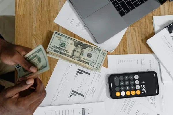 Managing check cashing expenses with cash and calculator
