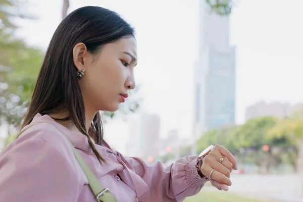 Woman Checking Time During Currency Exchange Waiting Delay